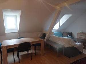 Pokój ze stołem, łóżkiem i biurkiem w obiekcie Gemütliche Dachwohnung w mieście St. Gallen