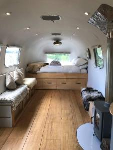 a bedroom with a dog laying on a bed in an rv at Airstream, vintage American caravan & Hottub in Ashburton