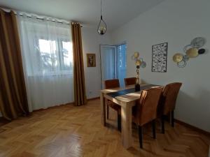 a dining room with a wooden table and chairs at High T in Kraljevo