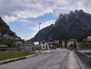 an empty street with a mountain in the background at Affittacamere Buon Riposo in Tarvisio