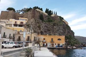 a group of buildings in front of a mountain at Casa Catalogna , Vicino al centro storico. in Lipari