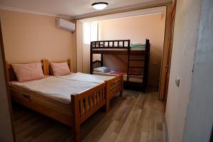 a small room with a bed and a bunk bed at Guesthouse Gua in Kutaisi