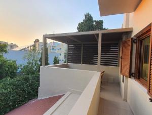 a balcony of a house with a window at Livas City Relaxing Apartment in Kos