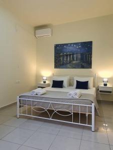 un letto in una camera con due lampade sopra di Livas City Relaxing Apartment a Città di Kos