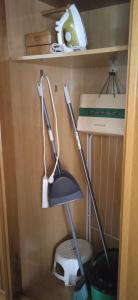 a broom in a corner of a room at La terrazuca in Santander