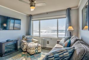 a living room with a couch and a chair and a window at Sea Gypsy Rentals in Lincoln City