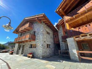 a building with wooden balconies on the side of it at Maison Carrel Elegant 4 in Breuil-Cervinia