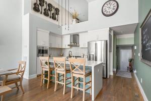 a kitchen with white cabinets and a table with chairs at FarmHouse Vibe on Centennial w garage and billiards in Nashville