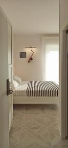 Кровать или кровати в номере Colombo 477 Stanze Jazz, Soul, Classica