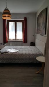 a bedroom with a large bed and two windows at Santa caterina in Crema