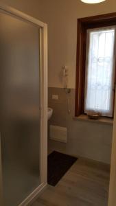 a bathroom with a door and a sink and a window at Santa caterina in Crema