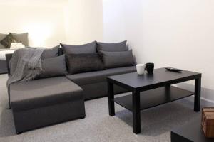 a living room with a couch and a coffee table at Spacious 1Bed Apartment in Heywood near CC in Heywood