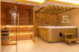 a sauna with a soaking tub in a room at Alexandras Palace in Bradford