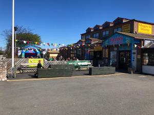 a street with benches in front of a building at 2 bedroom 6 berth Caravan Towyn Rhyl in Kinmel Bay