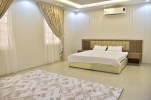 a bedroom with a bed and a rug on the floor at Comfort Stay in Taif