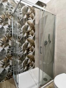 a shower stall in a bathroom with a wall at Sciantusa in Avola +30 photos