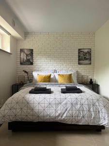 a bedroom with a large bed with a brick wall at Apartament Kwaskowa Góra in Kazimierz Dolny