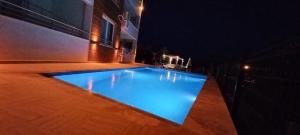 a large swimming pool in a building at night at Azize in Fethiye