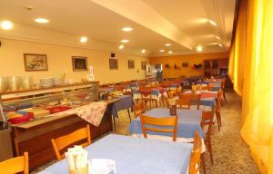 a restaurant with tables and chairs and a buffet at Hotel La Vela in Bellaria-Igea Marina