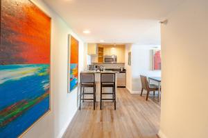 a kitchen with colorful paintings on the wall at Waterview Condo- Spacious 2 bedroom - Central - Steps to Beach in Fort Lauderdale