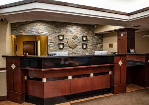 a lobby with a reception desk and a mirror at Comfort Inn & Suites in Hutchinson