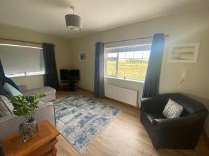 a living room with a couch and a chair at Loch Nuala in Galway