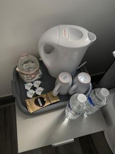 a bathroom counter with a toilet and water bottles on it at Nice Ensuite Rooms close to Anfield Stadium & city centre in Liverpool
