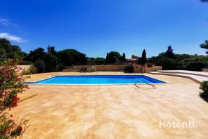 a swimming pool in the backyard of a house at Natural Escape Air-Conditioned T2 BIS Pools and Private Estate in Fitou! in Fitou