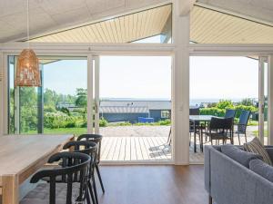 a dining and living room with a table and chairs at 6 person holiday home in Rønde-By Traum in Rønde