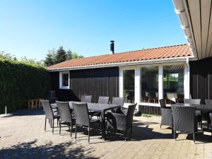 a table and chairs sitting on a patio at Holiday home Væggerløse CCXVI in Bøtø By