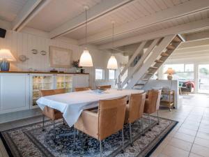 a kitchen and dining room with a table and chairs at Holiday home Fanø CCVIII in Fanø
