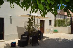 a patio with a table and an umbrella and chairs at Casacecilia relax in Siracusa