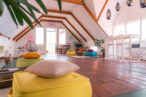 uma sala de estar com um repousa-pés amarelo no chão em Casa Ramona em Flores