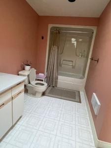 a bathroom with a shower and a toilet in it at Panoramic Ocean View in Nanaimo