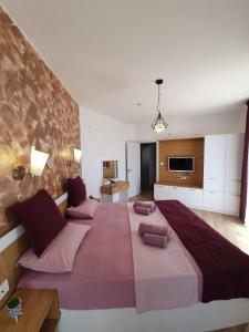 a large bed in a large room with a large bed sidx sidx sidx at Old Sailor Apartment in Obzor +37 photos