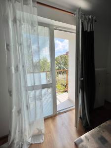 a room with a sliding glass door to a balcony at príjemné ubytovanie in Košice