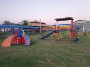 a group of playground equipment in a park at Casarão de frente para a lagoa de Praia Seca in Praia Sêca