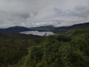 a view of a lake in the middle of a mountain at Glamping entre bosques in La Calera +3 photos