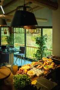 a table topped with lots of different types of food at OM Resort in Gura Teghii