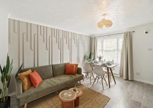 a living room with a couch and a table at East London House near tube with parking in London
