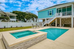 a swimming pool in front of a house at Grace by the Sea in Myrtle Beach