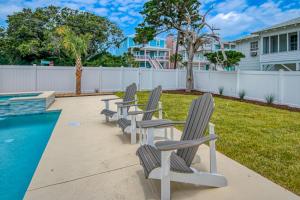 a row of lawn chairs next to a swimming pool at Grace by the Sea in Myrtle Beach