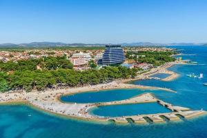 an aerial view of a beach with a large building at Villa Koraljka in Vodice