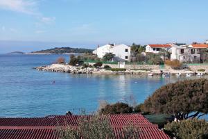 a view of a body of water with houses and boats at Apartments by the sea Rogoznica - 4805 in Rogoznica