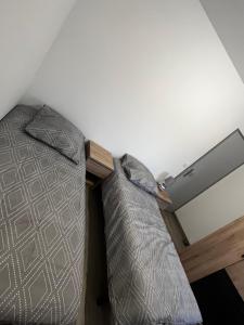 a bed in the corner of a room at CLAREN appart 57 in Longeville-lès-Saint-Avold