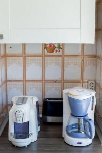 a kitchen with two coffee machines on a counter at Sunny Marisol T2 in Aroeira +24 photos