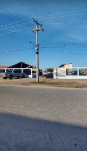 an empty street with a telephone pole and a truck at Pousada Rota das Dunas de Amaro in Santo Amaro