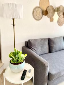 uma sala de estar com um sofá e uma mesa com uma planta em Detailed Villa - In Vilamoura's Heart em Vilamoura