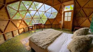 a large room with a bed in a wooden room at Glamping Magic Love in San Francisco