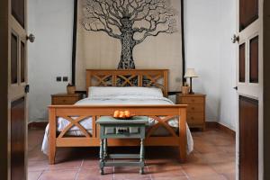 Un dormitorio con una cama y una mesa con naranjas. en Casa Andreas, en Periana